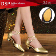 Gold dance shoes with 3.5 cm heel on wooden floor