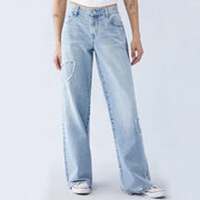 Front view of light blue embroidered side frayed jeans