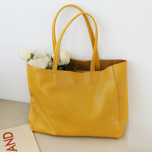 Yellow leather tote bag with flowers inside