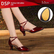 Red dance shoes with 5.5 cm heel on wooden floor