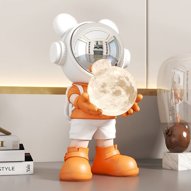 Orange space bear holding moon lamp on desk