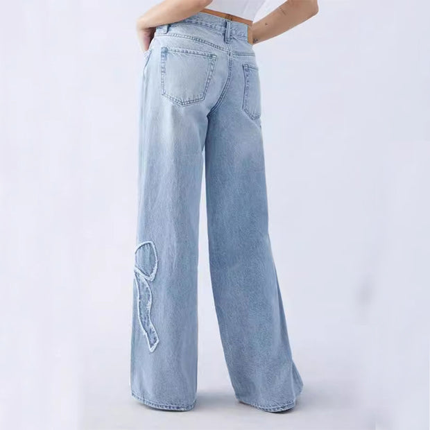 Back view of light blue embroidered side frayed jeans