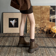 Back view of woman in brown chunky sole Chelsea boots