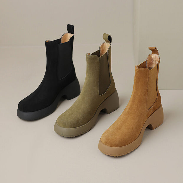 Three suede Chelsea boots in black, olive, and tan