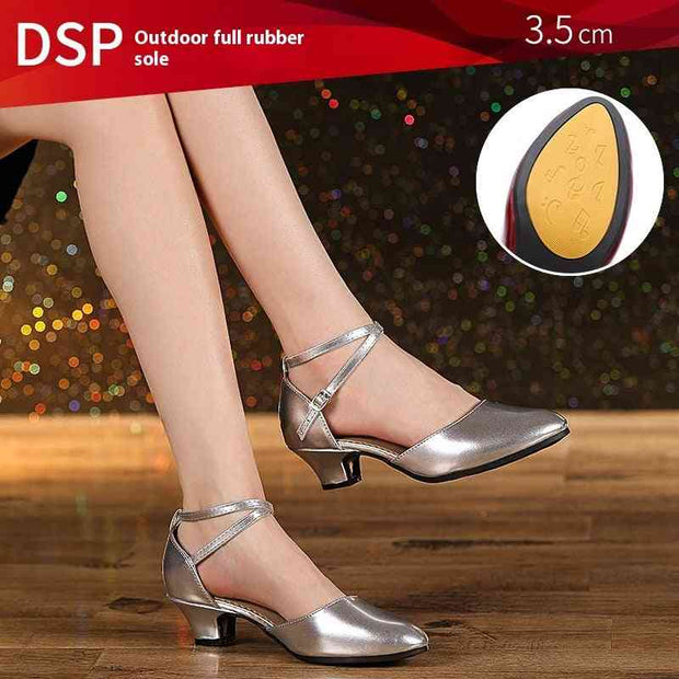 Silver dance shoes with 3.5 cm heel on wooden floor