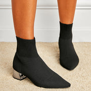 Black chunky heel knitted boots on feet