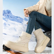 Woman wearing beige retro snow boots in snowy landscape