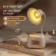 Phonograph lamp with music feature and dimming on a book