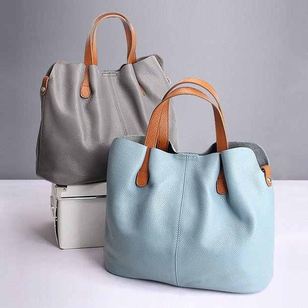 Gray and blue leather tote bags with brown handles