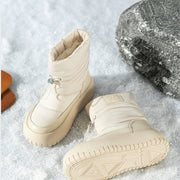 Pair of beige retro snow boots on snow