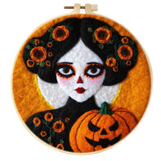 Halloween-themed wool felt painting with pumpkin and figure