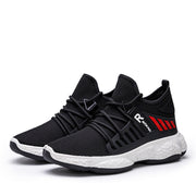 Pair of black mesh sports shoes with red accents.