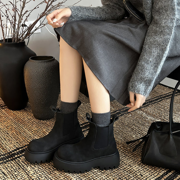 Woman wearing black chunky sole Chelsea boots