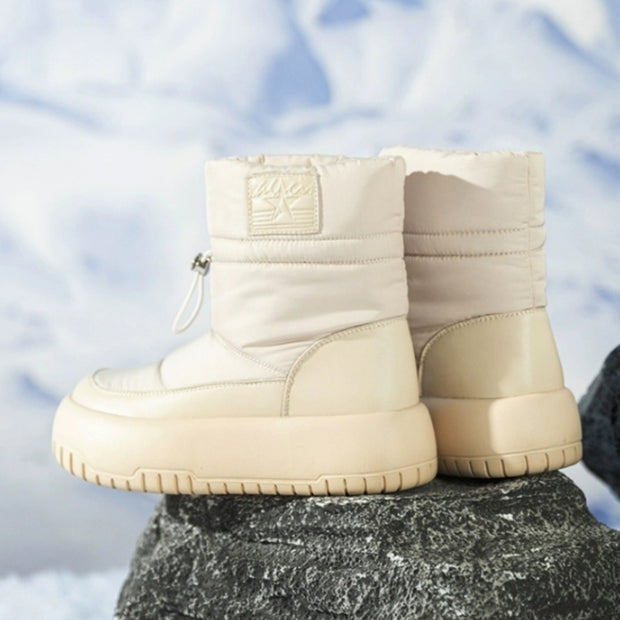 Beige retro snow boots on rock in snowy scene