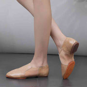 Beige leather dance training shoes on feet