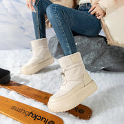 Beige retro snow boots on snow with skis