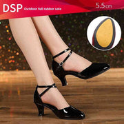 Black dance shoes with 5.5 cm heel on wooden floor