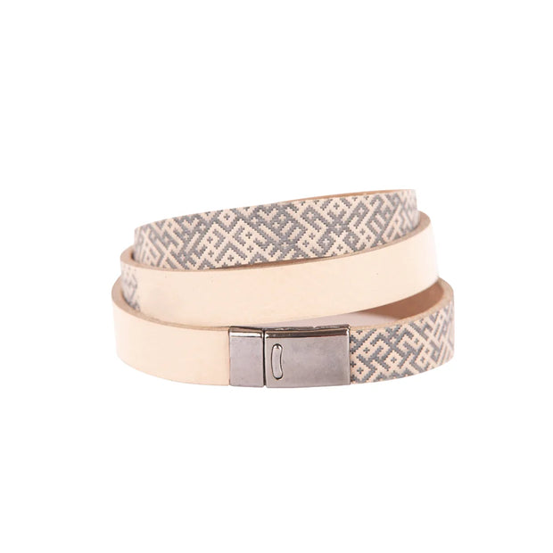 Beige leather bracelet with metal clasp and ethnic pattern