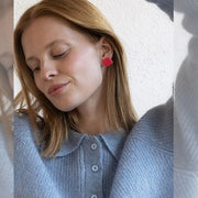 Model wearing red square leather earrings