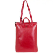 Front view of red structured leather tote bag with minimalist design, sturdy handles, and ample storage for everyday needs.