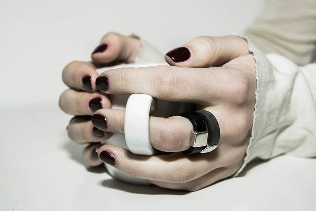 Hand wearing leather ring with bronze square detail