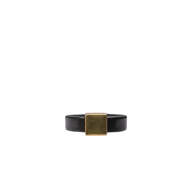 Leather ring with gold tone square detail on white background