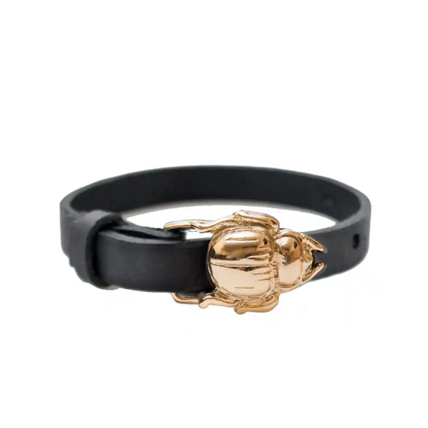 Scarab buckle bracelet in black leather with a gold-tone scarab design, versatile as a bracelet or choker necklace.