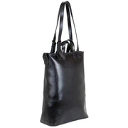 Side view of black structured leather tote bag with sleek design, adjustable strap, and durable construction for versatile styling.