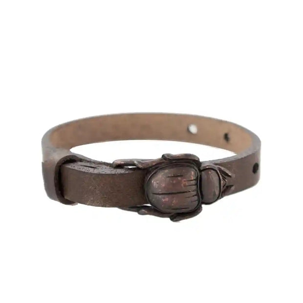 Brown leather scarab buckle bracelet with a copper-tone scarab design, suitable for casual or formal wear.