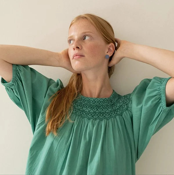 Model wearing circle shape leather earrings