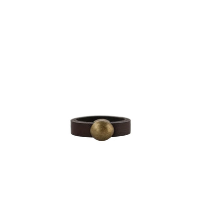 Leather ring with bronze tone circle detail on white background