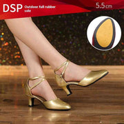 Gold dance shoes with 5.5 cm heel on wooden floor