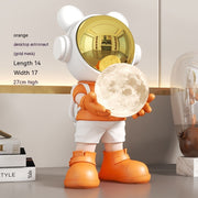 Orange astronaut bear with gold mask and moon lamp