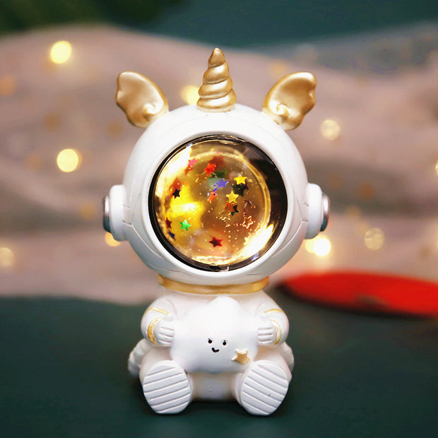 Unicorn-themed children's star light with golden accents and a glowing starry globe, adding a whimsical touch to any space.