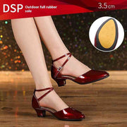 Red dance shoes with 3.5 cm heel on wooden floor