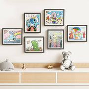 Colorful children's artwork in wooden frames.