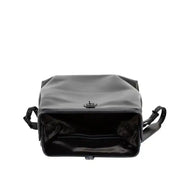 Interior view of a black leather backpack with a spacious compartment, ideal for fitting a 17-inch laptop and other items.