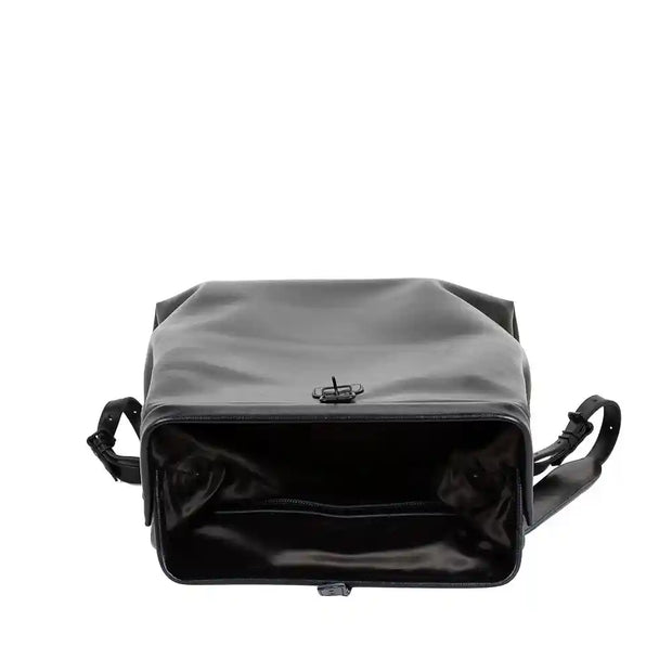 Interior view of a black leather backpack with a spacious compartment, ideal for fitting a 17-inch laptop and other items.